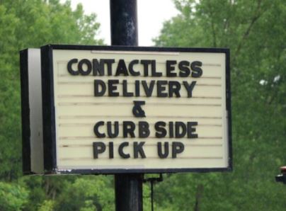 Road side sign shows curbside pickup
